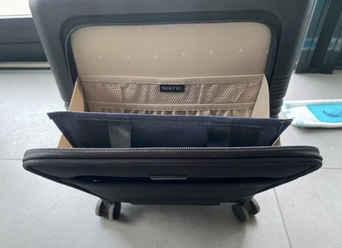 Aero Footrest lying flat in an open carry-on suitcase